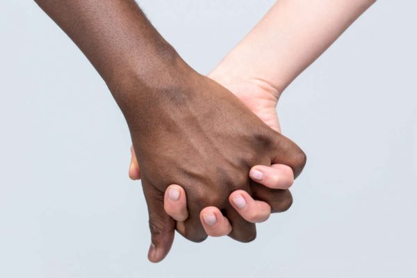White,Woman,,African,Man,Holding,Hand,Friendship,Symbol.,African,Peace