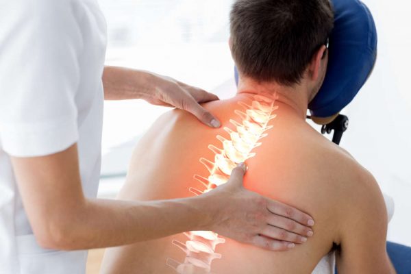 Digital,Composite,Of,Highlighted,Spine,Of,Man,At,Physiotherapy