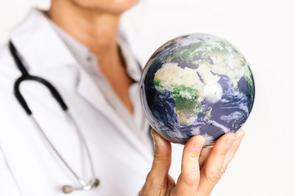 Female,Doctor,Holding,Planet,Earth,On,Her,Fingertips.,Showing,Africa